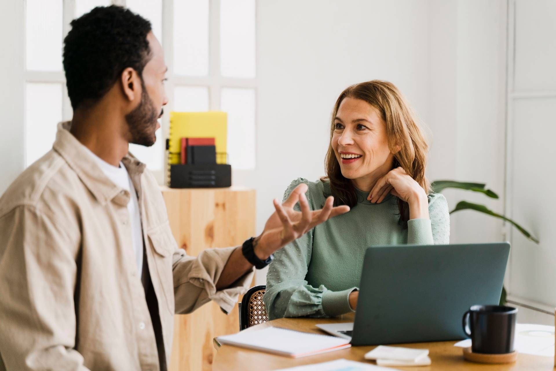People talking in front of a computer
